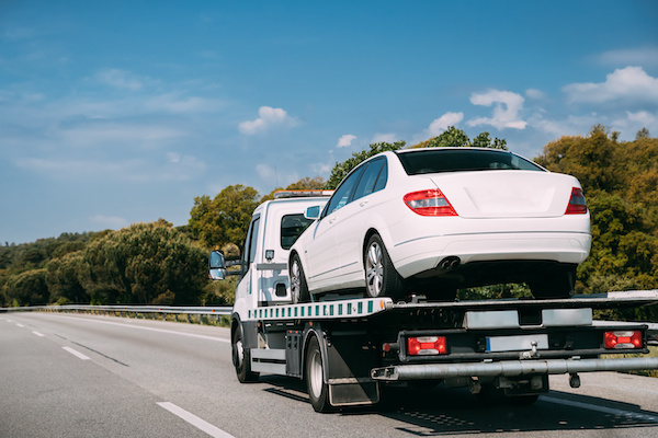 White Car Getting Towed by a Tow Truck | Snider Auto Care in Americus, GA